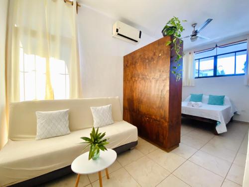 a living room with a couch and a bed at CABO BOHEMIA Tropical Garden Studios in Cabo San Lucas