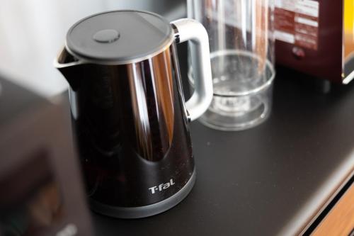 a coffee pot sitting on top of a counter at Naha Miharanosato -SEVEN Hotels and Resorts- in Naha