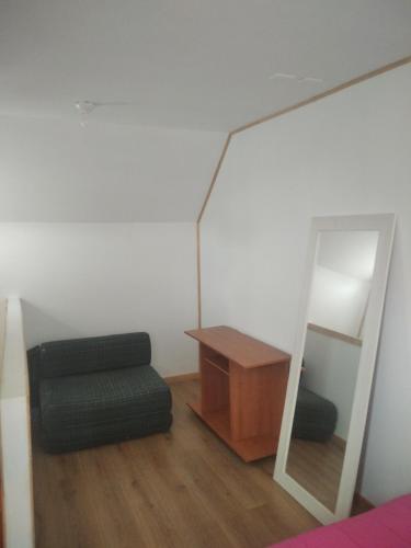 een kamer met een spiegel, een stoel en een tafel bij Pieza Labranza 