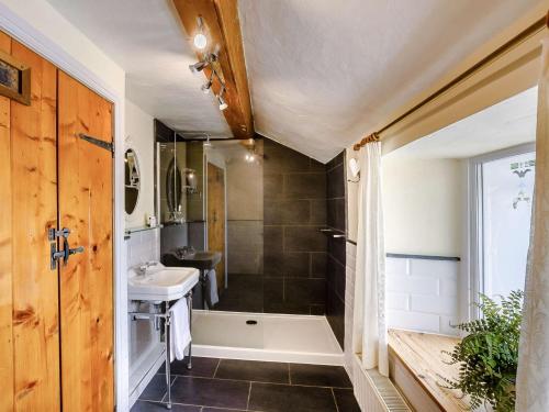 a bathroom with a sink and a bath tub at 1 bed in Cartmel 89364 in Cartmel