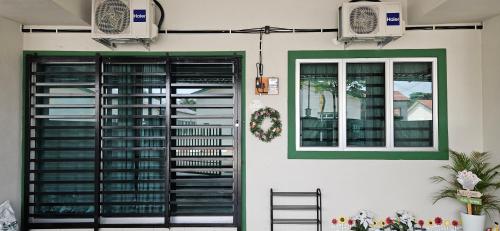 a house with a green and white door and a window at Teluk Intan Homestay Landed 3BR2B in Teluk Intan