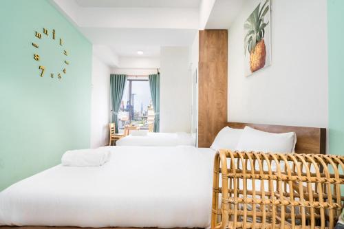 a bedroom with two beds and a balcony at Genius Apartment River Gate Free Pool in Ho Chi Minh City