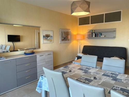 une cuisine et une salle à manger avec une table et des chaises dans l'établissement Bel appartement 1 chambre tout confort au bord de la mer avec balcon et parking - FR-1-323-216, à Saint-Jean-de-Monts