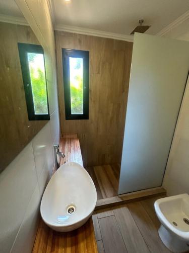 a bathroom with a white sink and a toilet at Sombras del Pinar in Necochea
