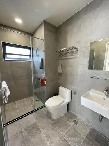 a bathroom with a toilet and a shower and a sink at Tian Central Light Brigade in Wujie