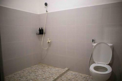 a bathroom with a shower with a toilet at SakaLoka Kebagusan in Jakarta