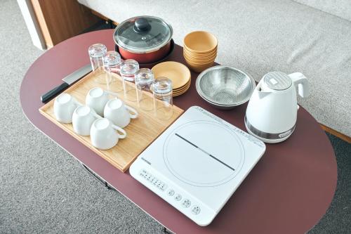 a table with a food scale and dishes on it at Rakuten STAY Naha Yachimun Street in Naha
