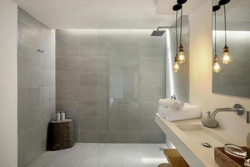 a bathroom with a shower and a sink at Telescope Villas Lombok in Kuta Lombok