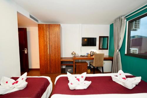 Postel nebo postele na pokoji v ubytování NT Elysian hotel