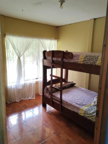 two bunk beds in a room with a window at Natural paradise in Turrialba