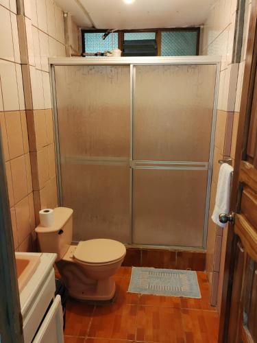 a small bathroom with a toilet and a shower at Natural paradise in Turrialba