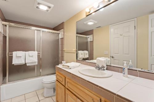 a bathroom with a sink and a toilet and a mirror at Oceanfront Family Getaway - BBQ - Oceanfront Seating in Oceanside