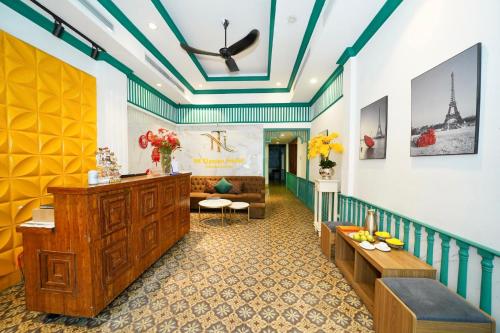 a lobby of a hotel with a staircase and a room at NT Elysian hotel in Hanoi