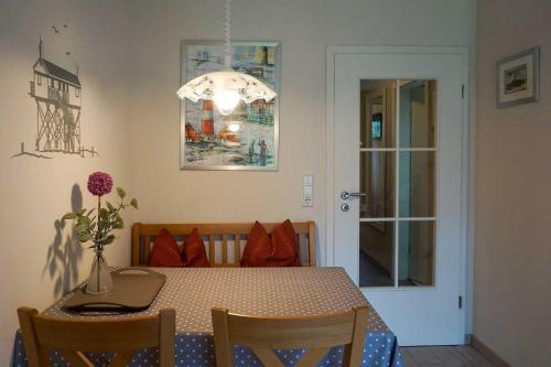 a dining room with a table and a light at DUeNENHOF-4 in Olsdorf