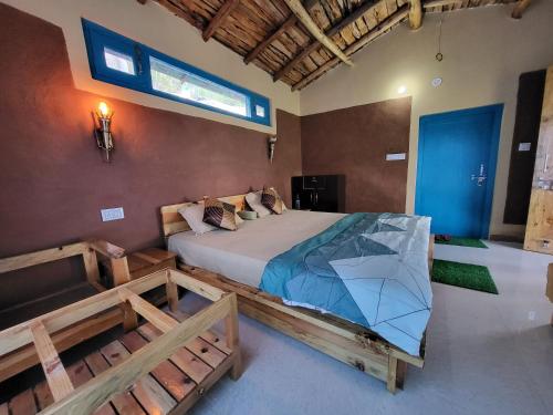 a bedroom with a bed in a room with a window at Zenoaks Homestay in Almora