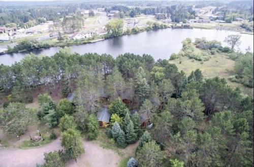 an aerial view of a house next to a lake at Fancy Fireflies Cabin in Hayward