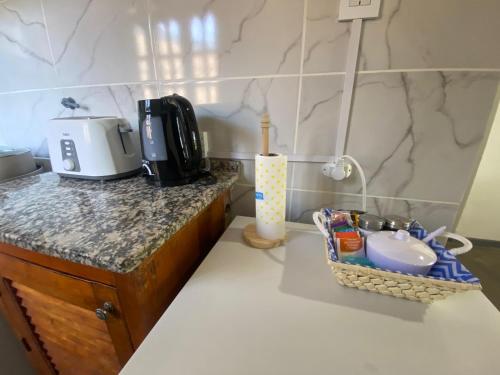 a kitchen counter with a coffee maker and a sink at DYCS DEPARTAMENTOS in San Rafael