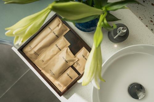 a plant sitting on a bathroom counter next to a sink at Thè HEM Hotel and Apartment in Da Nang