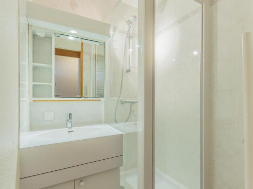 a white bathroom with a sink and a shower at Appartement La Plagne-Tarentaise, 1 pièce, 4 personnes - FR-1-351-131 in La Plagne Tarentaise