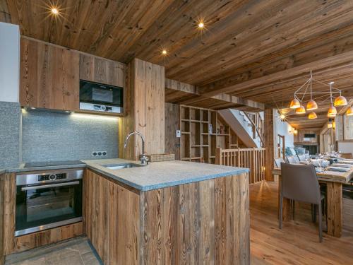 a kitchen with a sink and a counter in a cabin at Chalet de luxe lumineux avec panorama, WIFI, garage, balcons et services haut de gamme, Val-d'Isère - FR-1-694-344 in Val dʼIsère