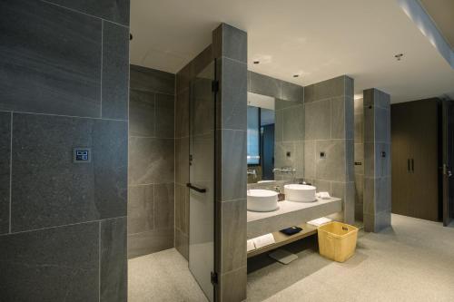 a bathroom with two sinks and a shower at Novotel Nantong Center in Nantong
