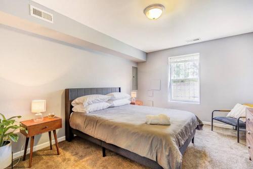 a bedroom with a bed and a table and a window at Spacious Suite in Deanwood + Free Parking in Washington, D.C.