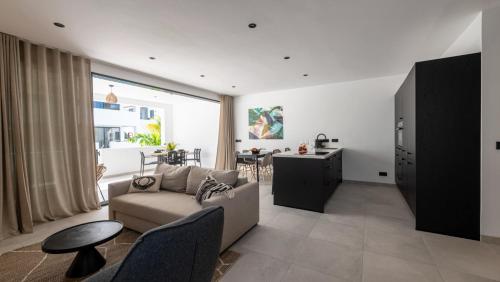 a living room with a couch and a table at Indigo Suite Curaçao - A Brand New Modern Apartment on a secure resort close to the Beach in Jan Thiel