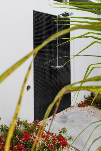 a black door with a metal grating on it at Indigo Suite Curaçao - A Brand New Modern Apartment on a secure resort close to the Beach in Jan Thiel