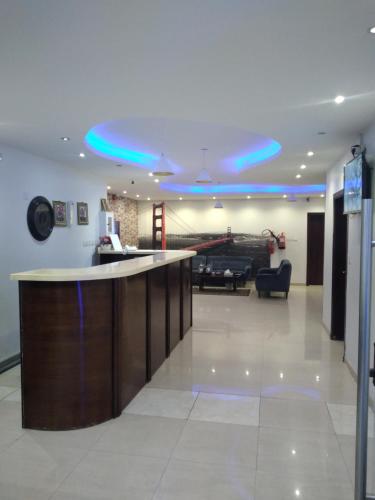 a lobby with a bar with blue lights on the ceiling at سحاب فيو in Abha
