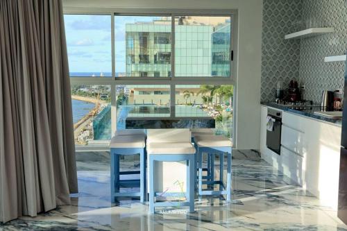 a kitchen with a bar with a view of the ocean at Guest Friendly Cartagena 2BR Jacuzzi stripper pole in Cartagena de Indias
