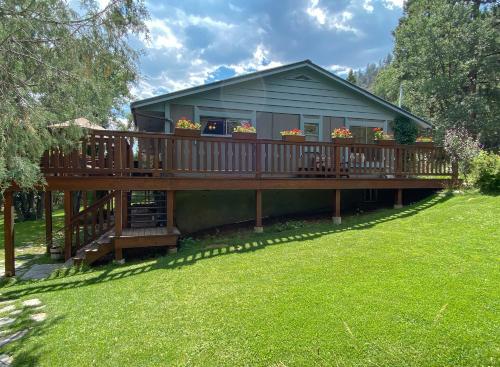 a house with a deck with flowers on it at Country Sunshine Bed and Breakfast in Durango