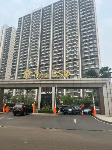 a large building with a sign on the front of it at Sky House BSD Studio by Shinzhouz in Cilandak