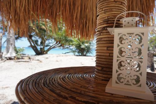 a lantern sitting on top of a wooden table on the beach at Cayo Coco - Island Glamping All-Inclusive in Barangonan