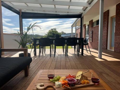 a table with a tray of food on a patio at Cosy Beach House - Near Hot Springs. in Tootgarook