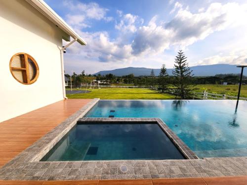 a swimming pool in the backyard of a house at Ada Pool Villa Khaoyai in Pong Talong