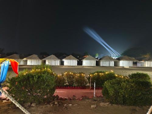 a row of huts at night with lights at Awar Desert Safari in Jaisalmer
