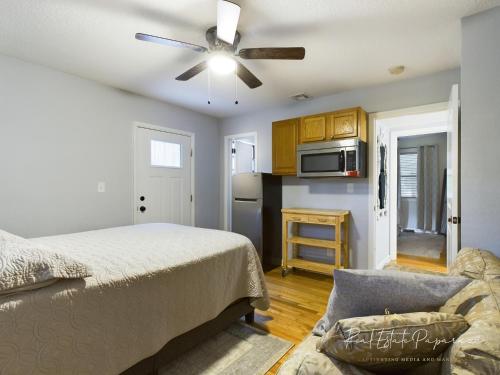 a bedroom with a bed and a ceiling fan at The POSH FLEX Renovated Mid Century Modern 3BR 2B Heart of The City 3 Mins to JU 5 Mins to Downtown 10 Mins Jax Cruise 15 Mins to Beach 15 Mins to MAYO Clinic in Jacksonville