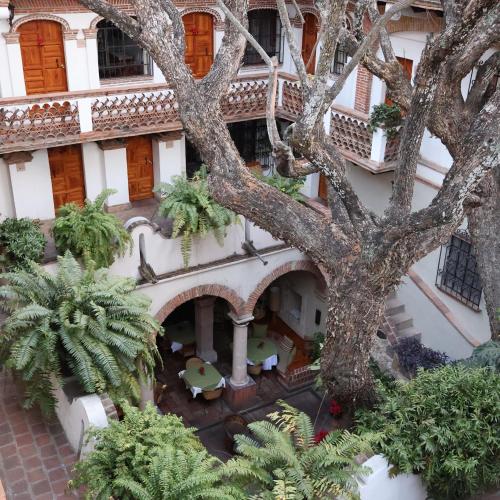 an overhead view of a building with a tree at Hotel los Arcos in Taxco de Alarcón