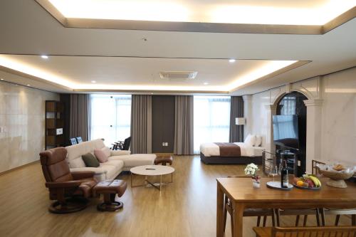 a living room with a couch and a table at Benikea hotel seosan in Seosan