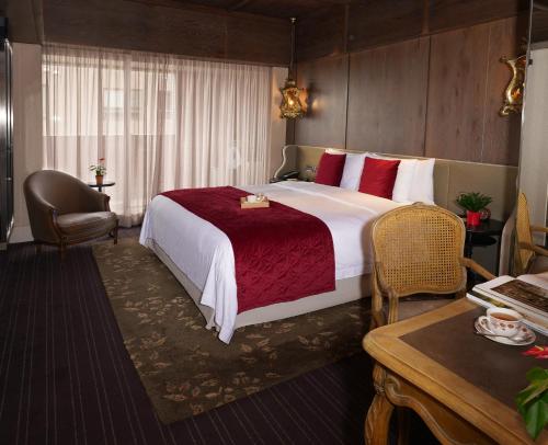 a hotel room with a large bed and a desk at Palais de Chine Hotel in Taipei