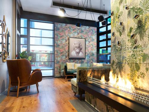 a living room with a fireplace and a couch at Ovolo Central in Hong Kong