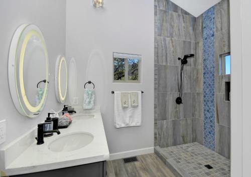 a white bathroom with a sink and a shower at Cathedral Casita where indulgence meets peace and tranquility! in Sedona
