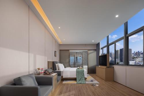 a hotel room with a bed and a view of a city at Shenzhen Zhongchen International Hotel - Shenzhen Baolong Subway Station Branch in Shenzhen