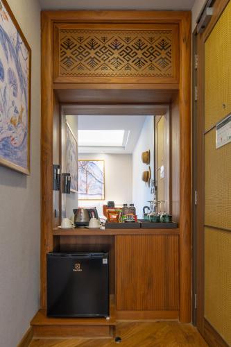 a door with a mirror in a room at Chala Number6 in Chiang Mai
