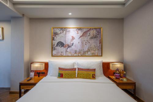 a bedroom with a large bed with two night stands at Chala Number6 in Chiang Mai