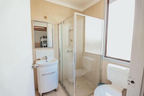 a bathroom with a shower and a toilet and a sink at Eaglehawk Park Canberra in Canberra