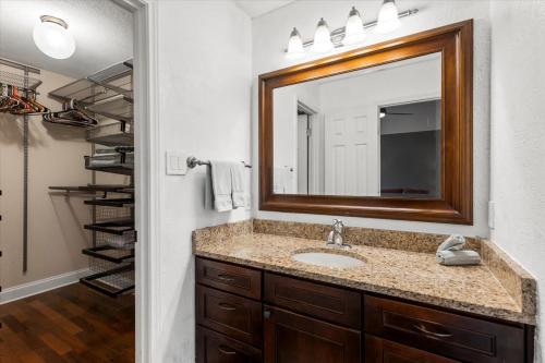 a bathroom with a sink and a mirror at Spacious Retreat W Private Pool & Plenty of Space in Austin