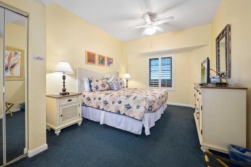 a bedroom with a bed and a ceiling fan at Beach Paradise Penthouse Ocean Walk Resort Daytona in Daytona Beach