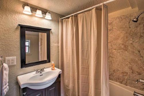 a bathroom with a sink and a shower curtain at Palm Wave Stays - Central and Cozy Apt in West Palm Beach