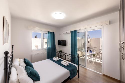 a bedroom with a bed and a view of a balcony at Accomoteleia Crystal Lagoon Villa in Protaras